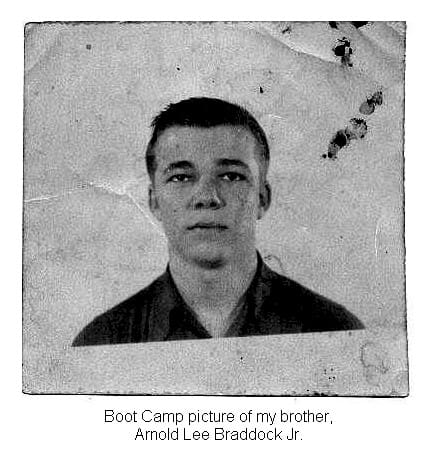 A black and white photo of a man with a picture of his brother.