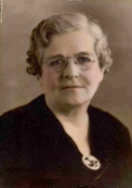 A woman with glasses and a black jacket