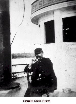 A man sitting on the deck of a boat.