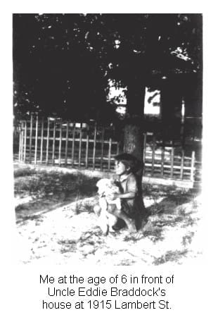 A black and white photo of two children in the grass.