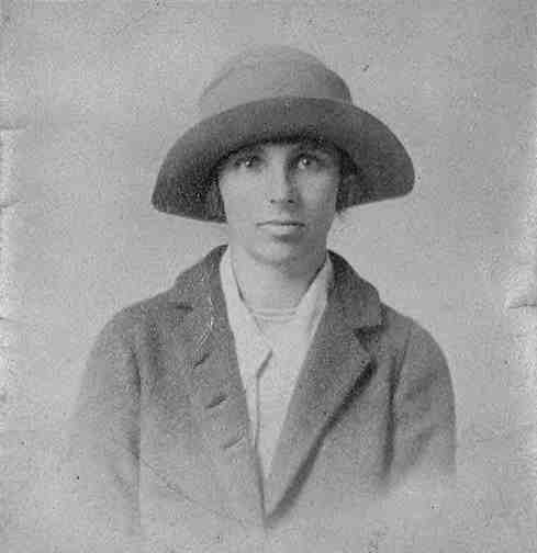A man in a hat and jacket.