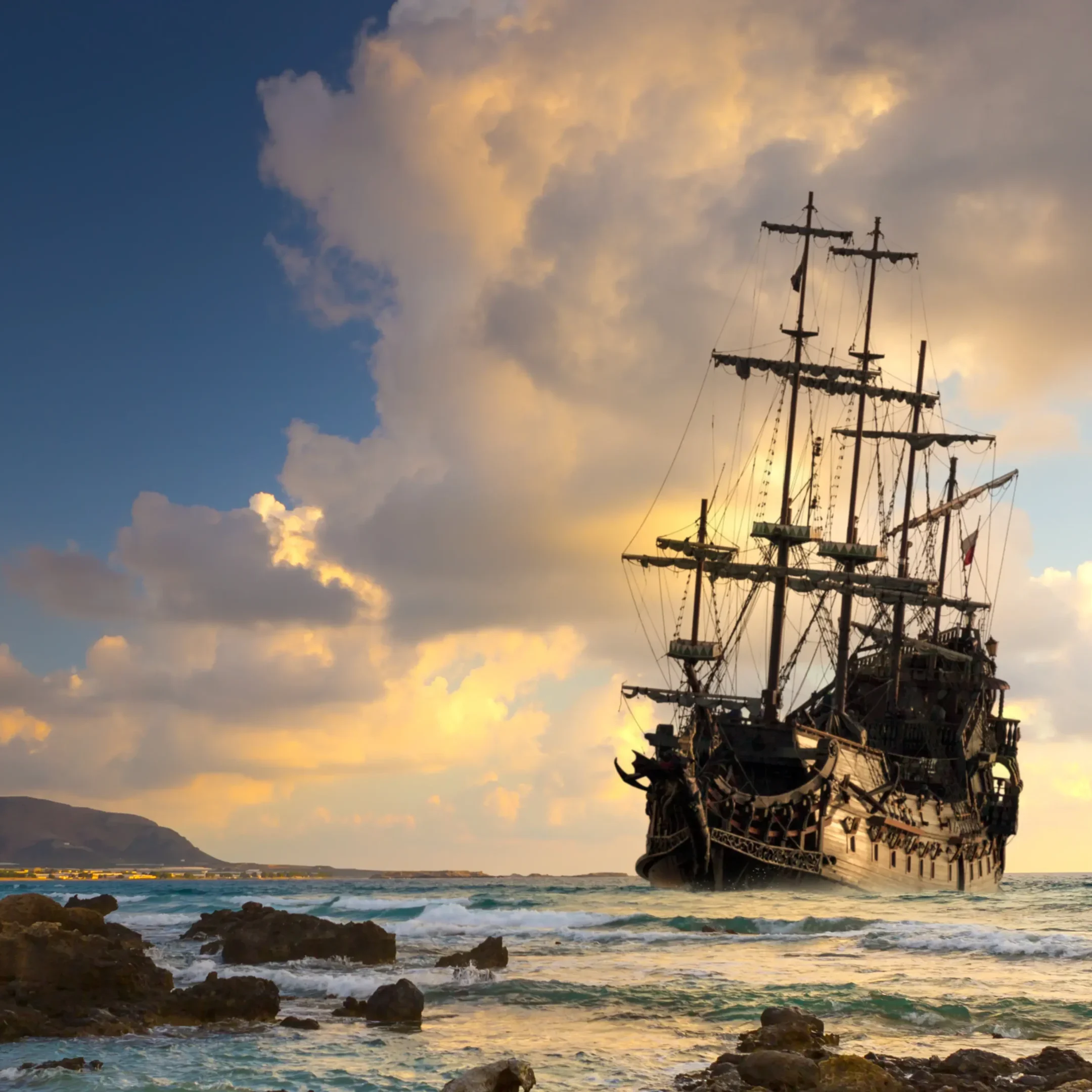 A pirate ship in the ocean with clouds above.
